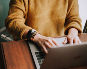 surveryImage a person typing on a laptop